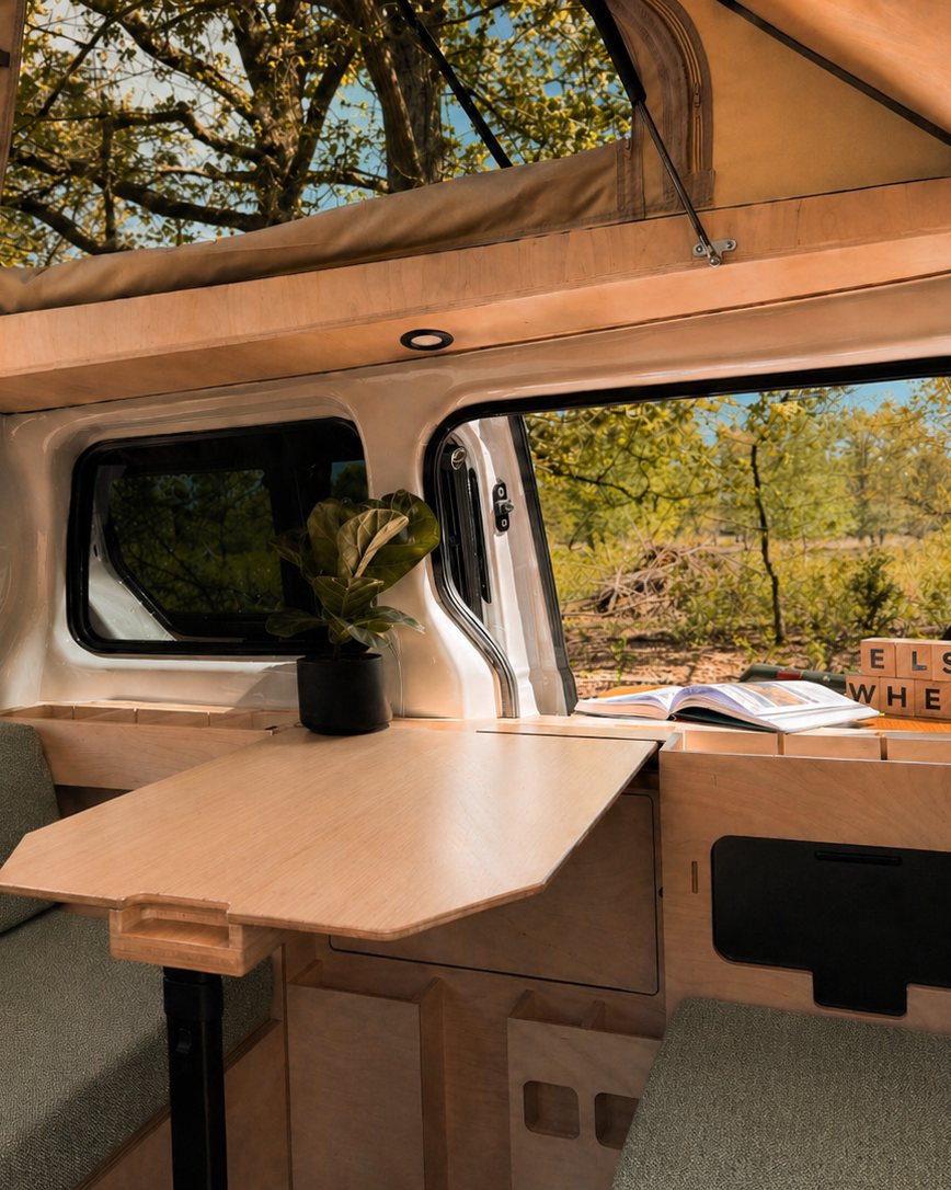 Van interior with table, plant and ELSEWHERE blocks